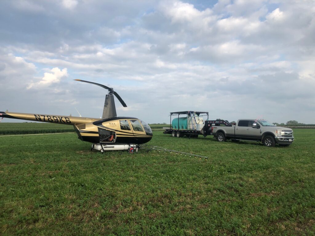 crop spraying helicopter with a mobile mix trailer
